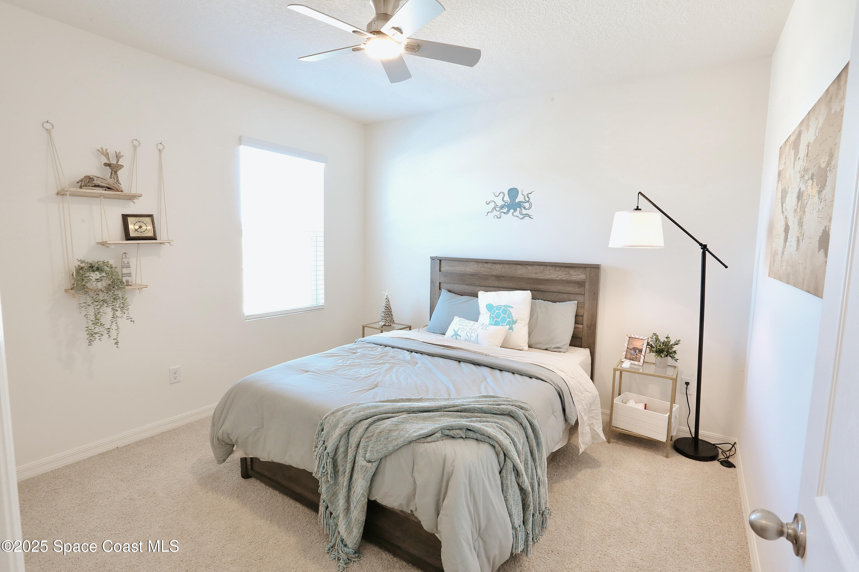 1217 Casey Avenue Rockledge, FL 32955 - Photo 37 of 49 a bedroom with a large bed and a chandelier