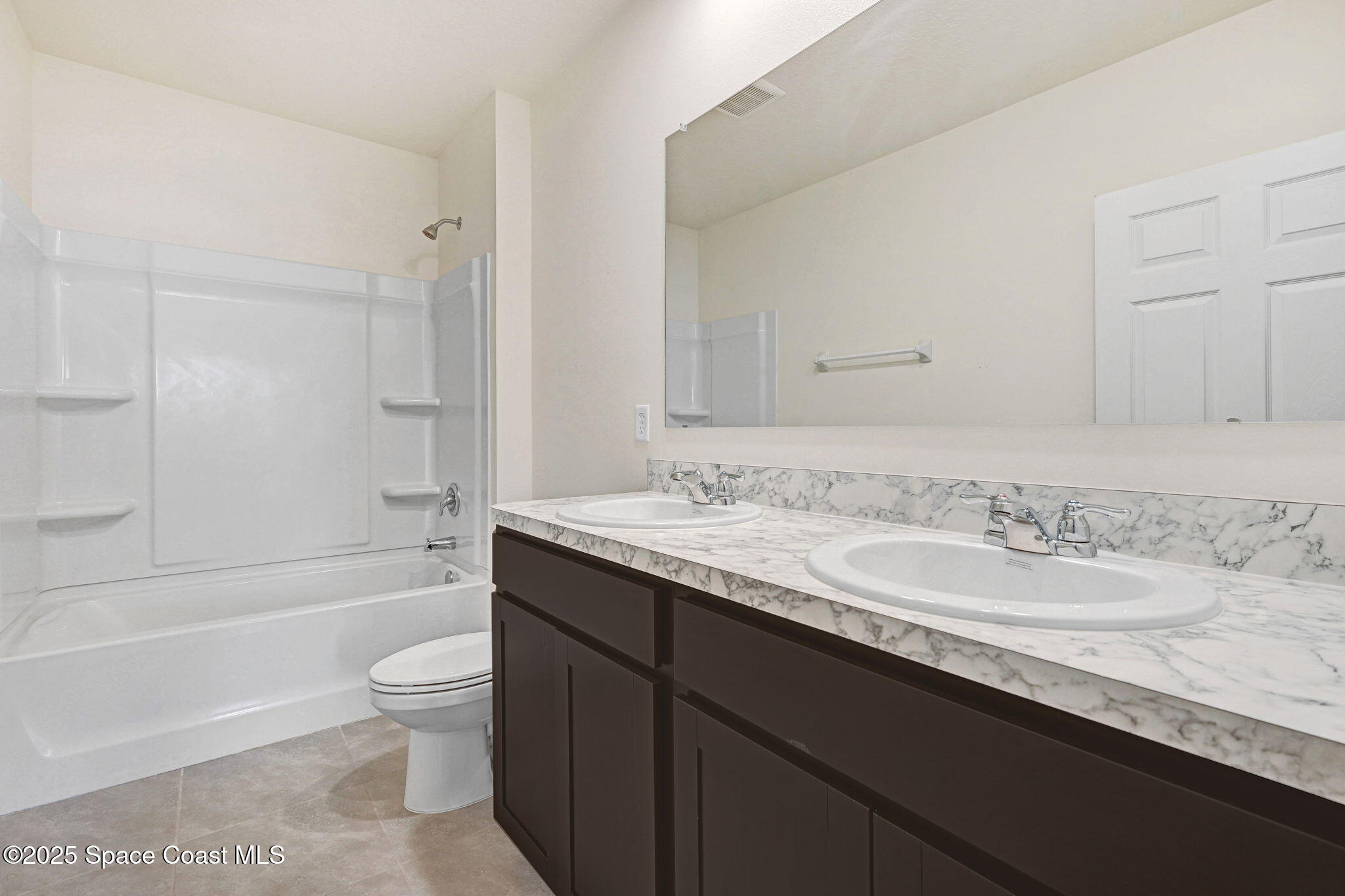 1217 Casey Avenue Rockledge, FL 32955 - Photo 38 of 49 a bathroom with a granite countertop sink a toilet and bathtub