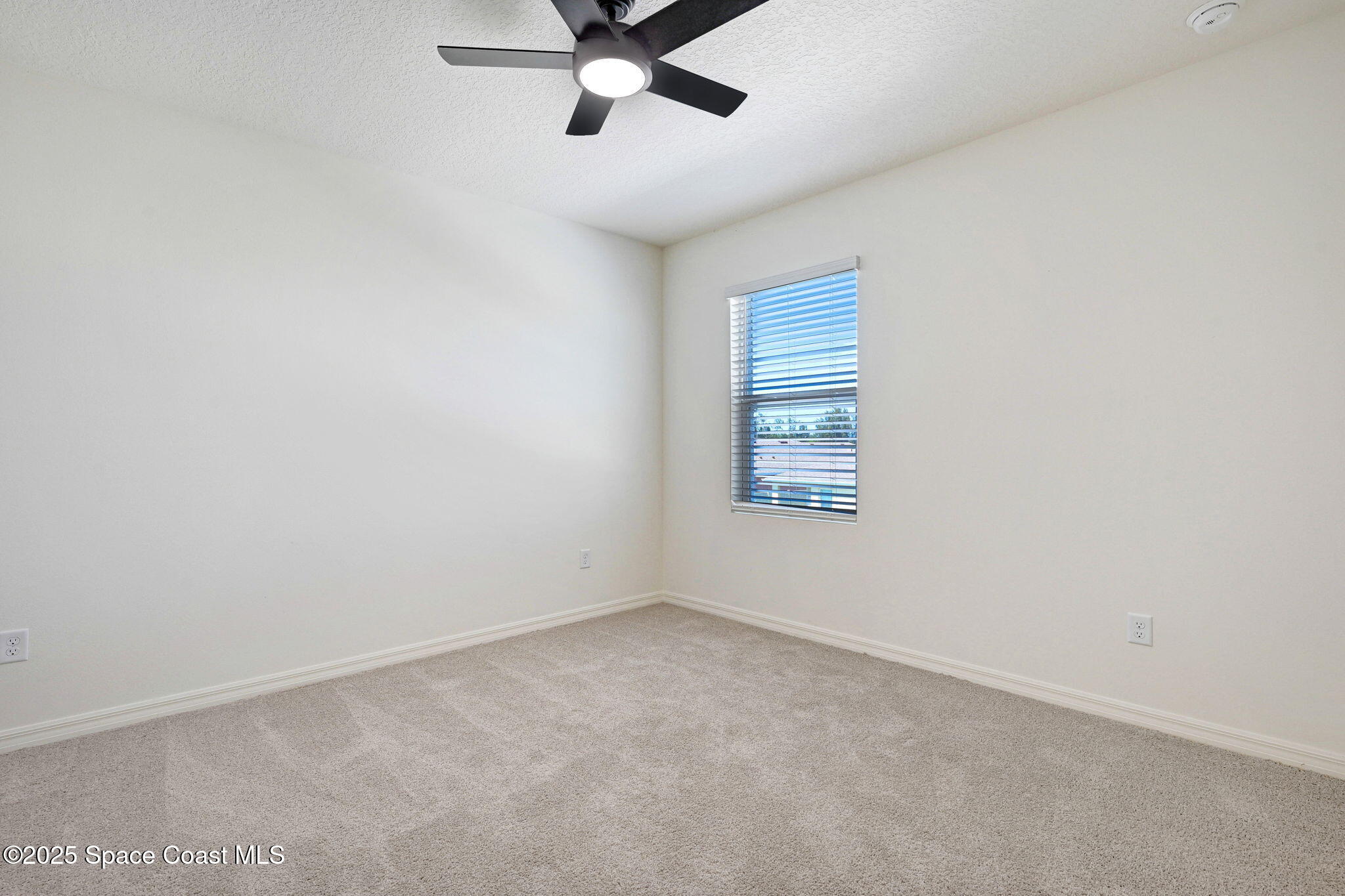 1217 Casey Avenue Rockledge, FL 32955 - Photo 40 of 49 an empty room with a window and a fan