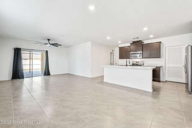 a view of kitchen with kitchen island and stainless steel appliances