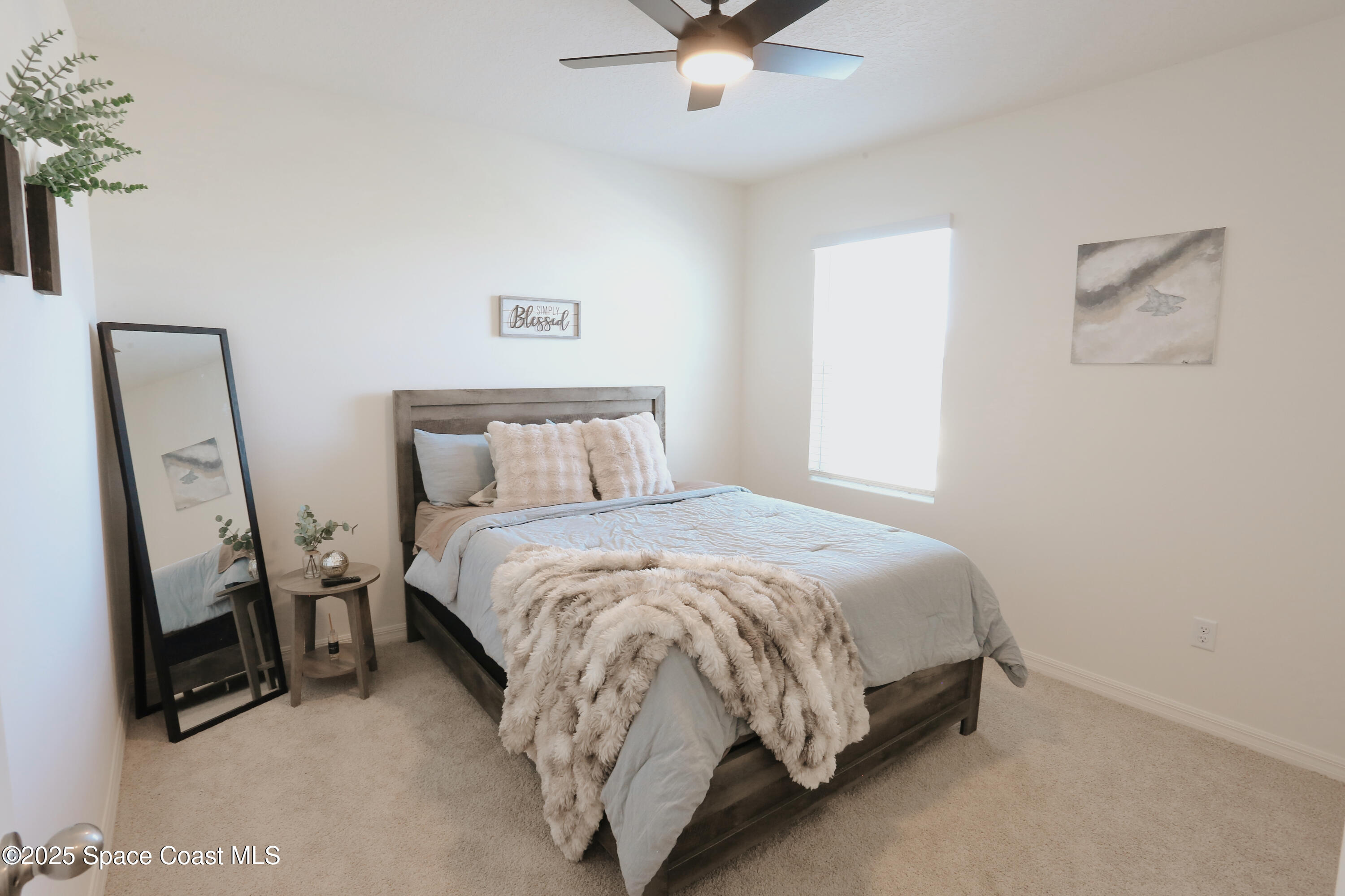 1217 Casey Avenue Rockledge, FL 32955 - Photo 41 of 49 a bedroom with a bed and a flat tv screen