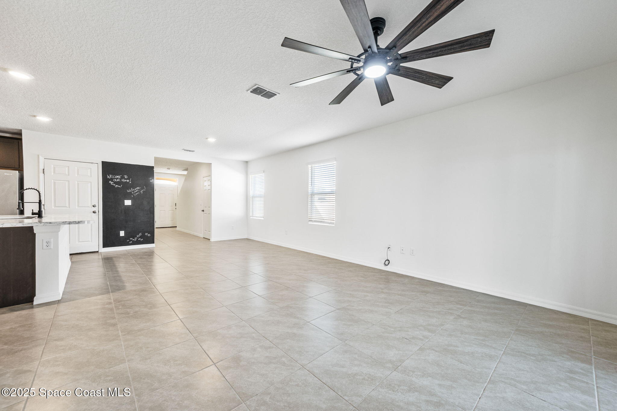 1217 Casey Avenue Rockledge, FL 32955 - Photo 8 of 49 an empty room with fan and a ceiling fan