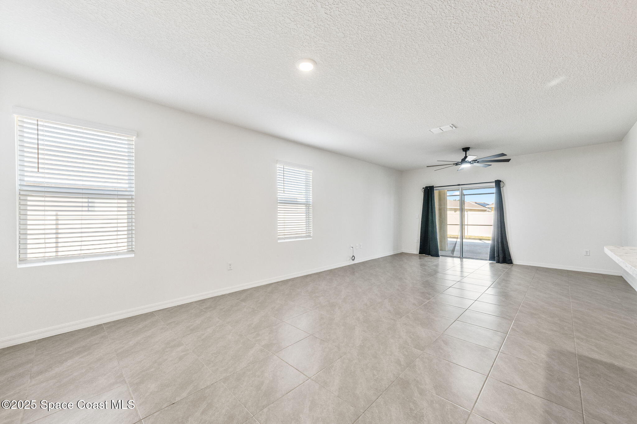 1217 Casey Avenue Rockledge, FL 32955 - Photo 9 of 49 an empty room with windows and closet