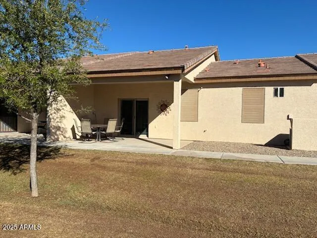 a view of a terrace with furniture and floor to ceiling window