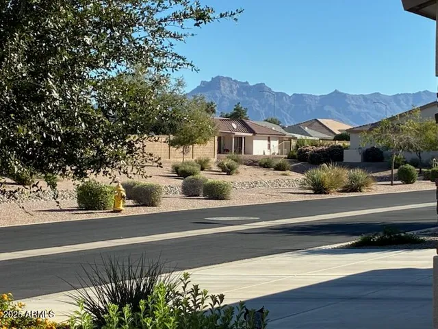 a view of a house with a swimming pool and a yard