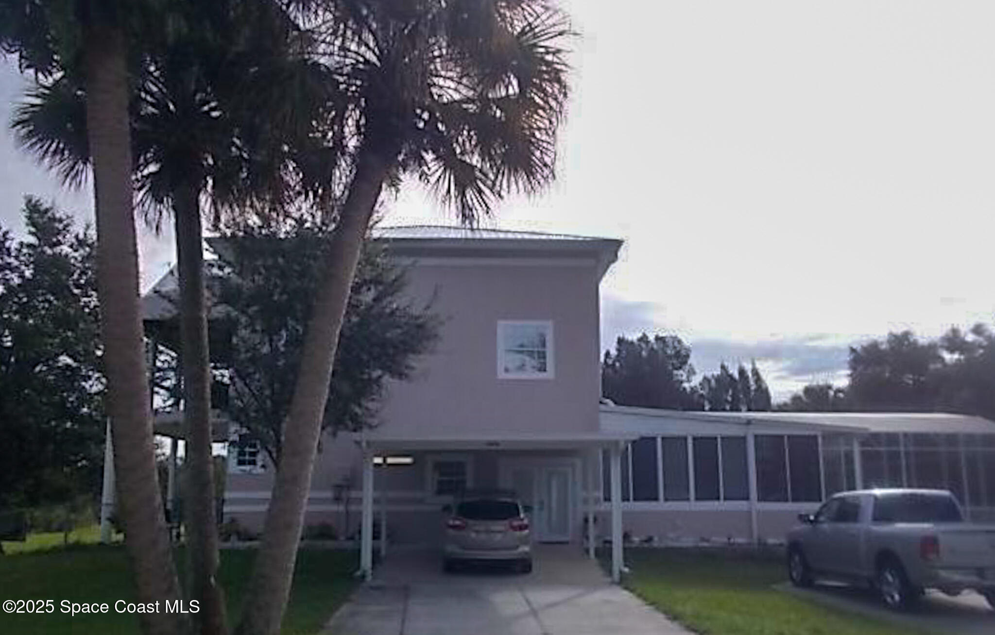 3455 Hield Road Melbourne, FL 32904 - Photo 1 of 1 a view of a house with a small yard and a large tree