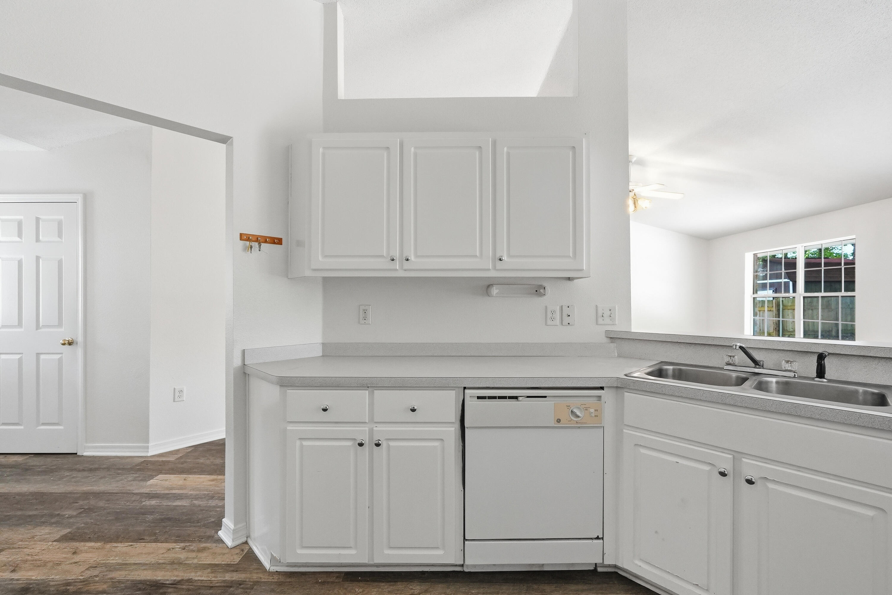 4087 Audiss Road Milton, FL 32583 - Photo 19 of 34 a kitchen with granite countertop white cabinets and a sink