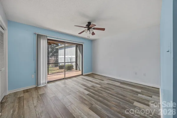 a view of a hallway with wooden floor and closet