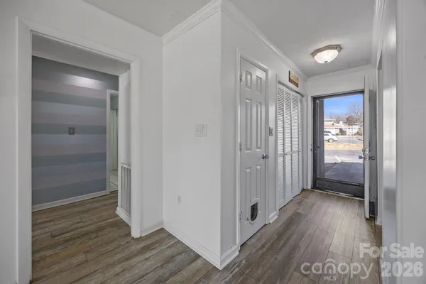 a view of hallway with wooden floor