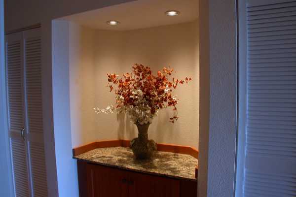366 Papaloa Road, Unit 1C Kapaa, HI 96746 - Photo 7 of 11 a vase of flowers sitting on a wooden floor