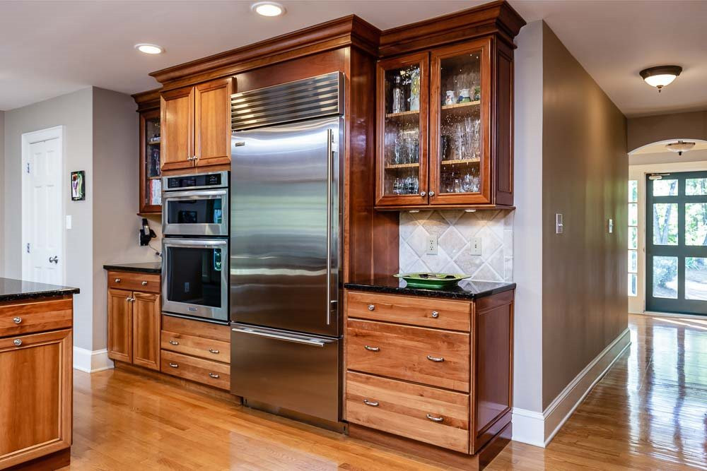 3000 Upland Circle Raleigh, NC 27607 - Photo 4 of 30 a kitchen with stainless steel appliances kitchen island granite countertop a refrigerator and cabinets