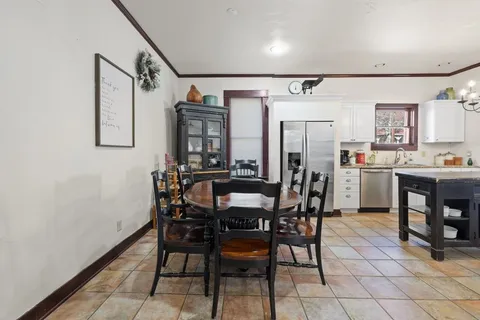 a dining room with furniture and window