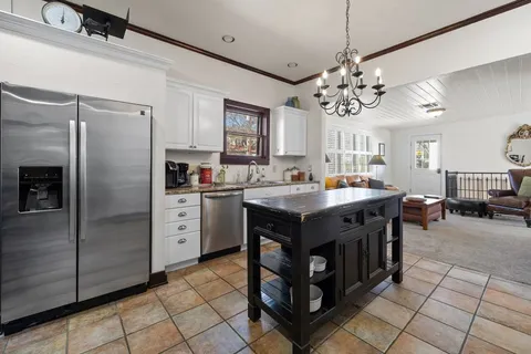 a kitchen with stainless steel appliances granite countertop a stove a refrigerator a sink and dishwasher