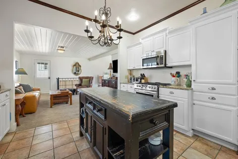 a kitchen with a stove cabinets and window