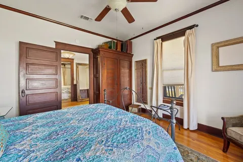 a bedroom with a large bed and a dresser