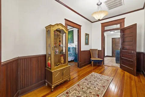 a living room with furniture rug and wooden floor