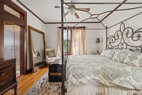 a bedroom with a large bed and a window