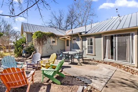 a view of a patio with table and chairs and potted plants