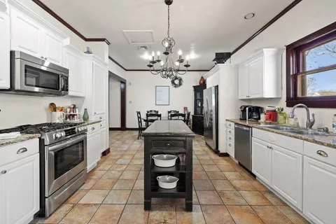 a kitchen with stainless steel appliances granite countertop a stove and a sink