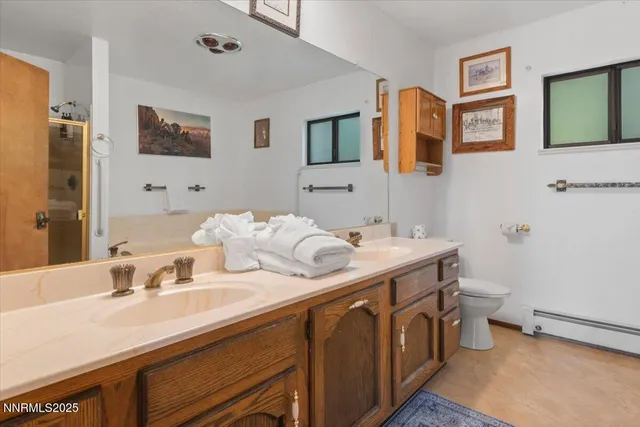 a bathroom with a double vanity sink and a mirror