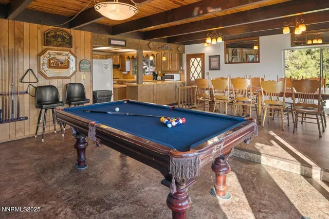 a kitchen with kitchen island granite countertop a sink stove and cabinets