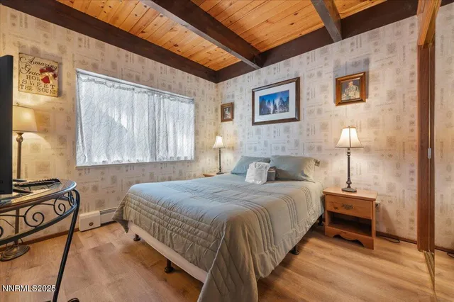 a bedroom with a bed and a painting on the wall