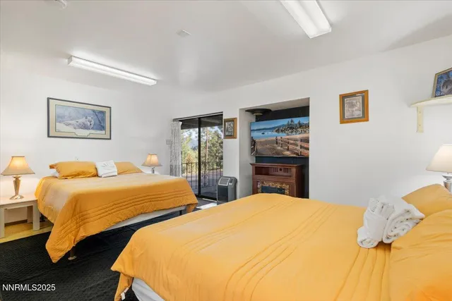 a bedroom with two beds and a lamp