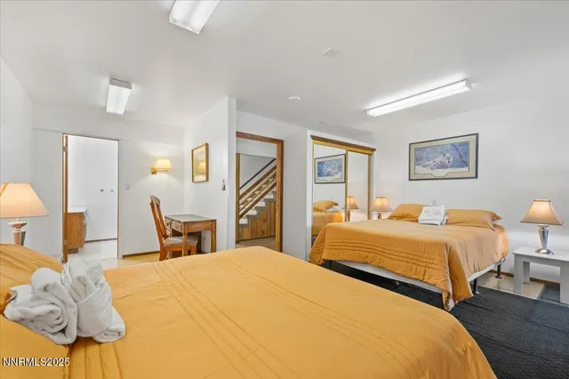 a bathroom with a sink mirror and a shower