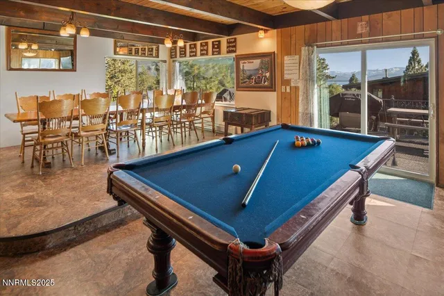 a room with pool table and windows