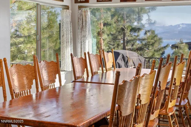 a view of a living room and floor to ceiling window with furniture