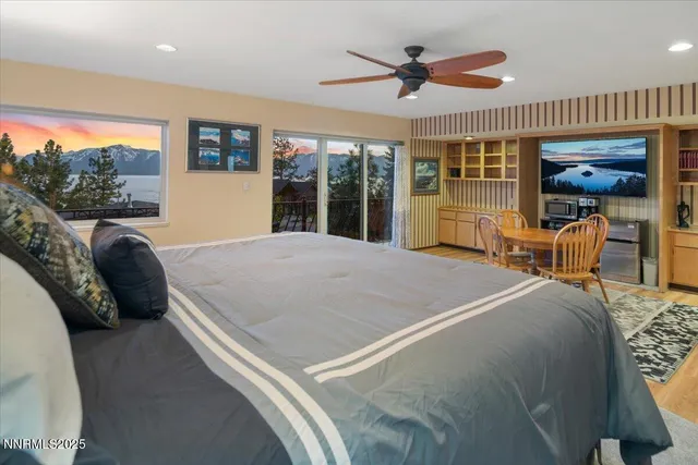 a bed room with a bed and a large window