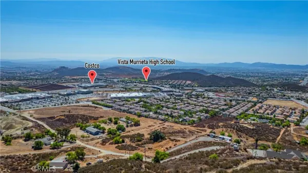 an aerial view of a houses with a yard