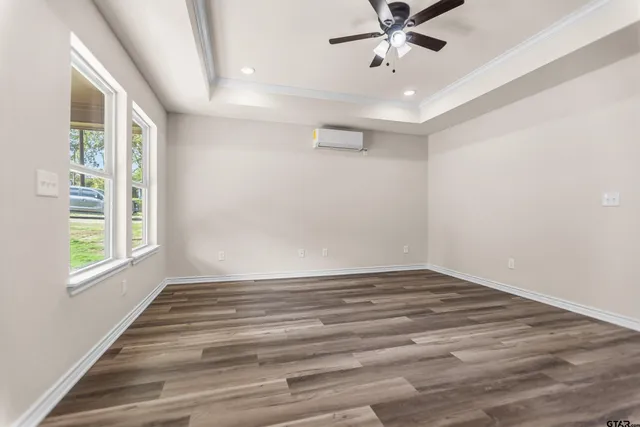 wooden floor in an empty room with a window