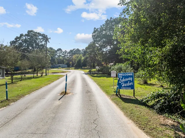 a view of swimming pool with a yard and large trees