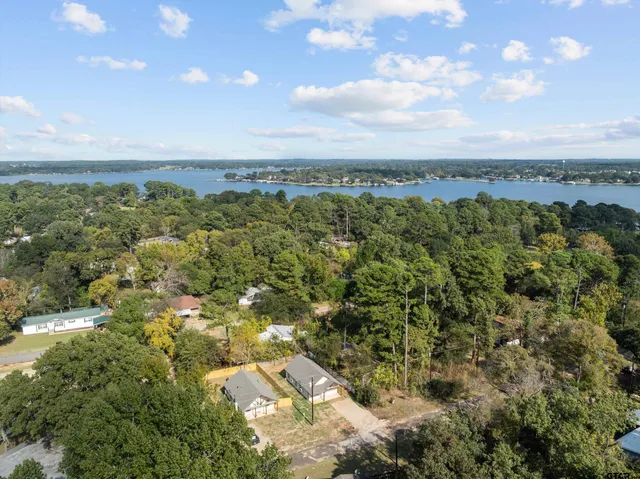 an aerial view of a city with lots of residential buildings and mountain view in back