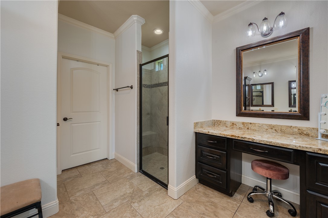 3301 Covington Court Bryan, TX 77808 - Photo 13 of 26 a bathroom with a granite countertop sink a mirror and a vanity
