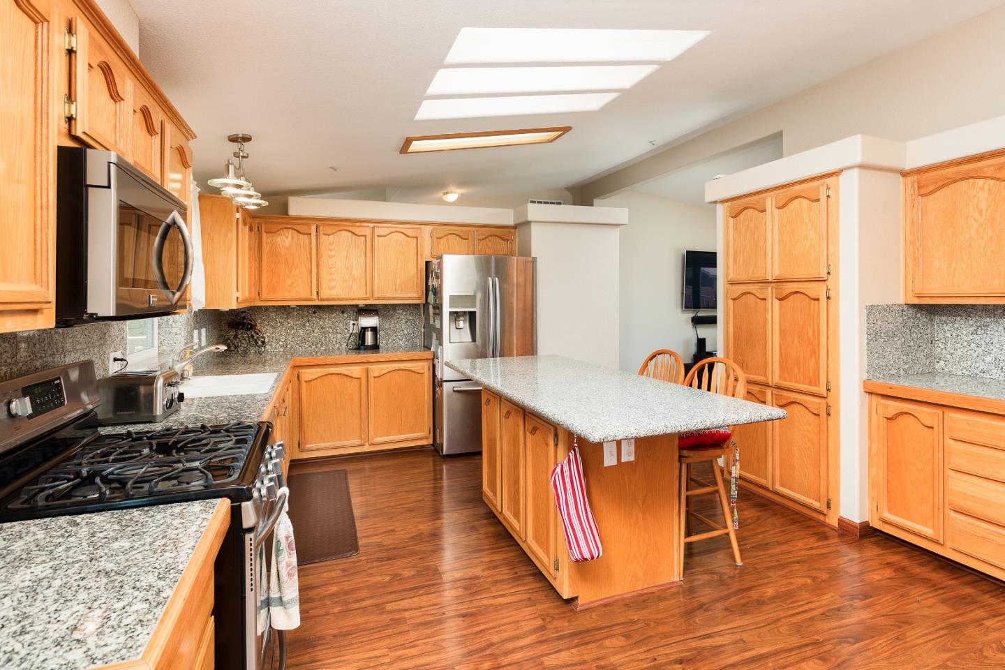 275 Orchard View Drive Watsonville, CA 95076 - Photo 8 of 25 a kitchen with stainless steel appliances granite countertop a stove a sink dishwasher and a refrigerator with wooden floor