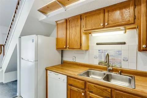 a kitchen with a sink and a refrigerator