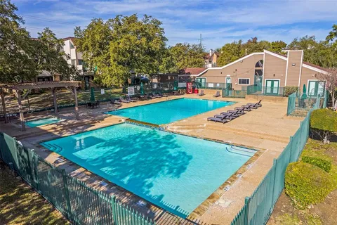 a front view of a house with swimming pool and yard
