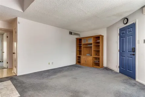an empty room with a closet and cabinet