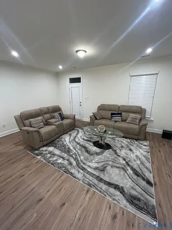 a open kitchen with a sink dishwasher a dining table chairs refrigerator and cabinets