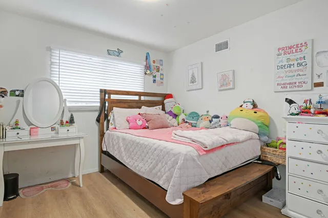 a bedroom with a bed and a desk