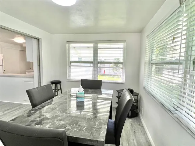a view of a dining room with furniture and a window