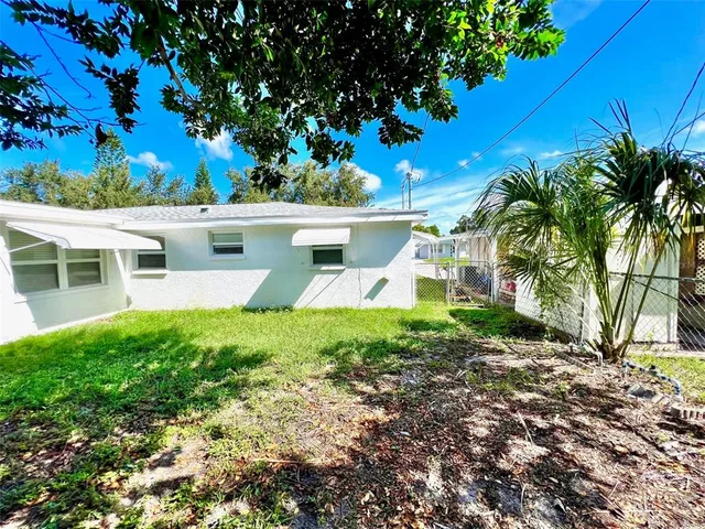 a view of a house with a backyard