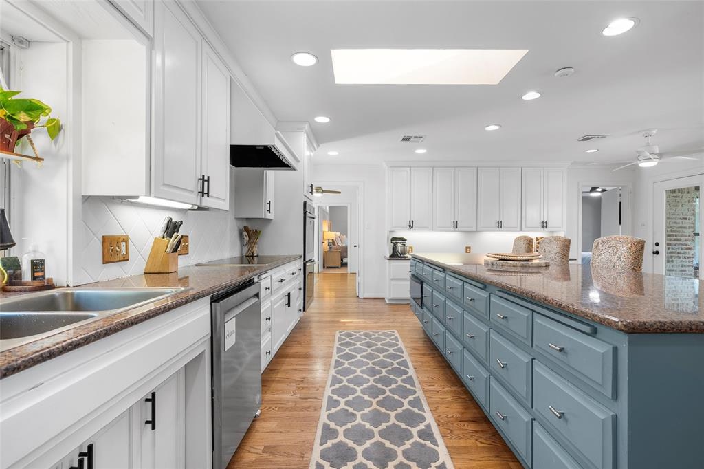 1396 Eagle Canyon Drive China Spring, TX 76633 - Photo 15 of 40 Kitchen featuring white cabinetry, stainless steel appliances, a skylight, a kitchen island, and recessed lighting