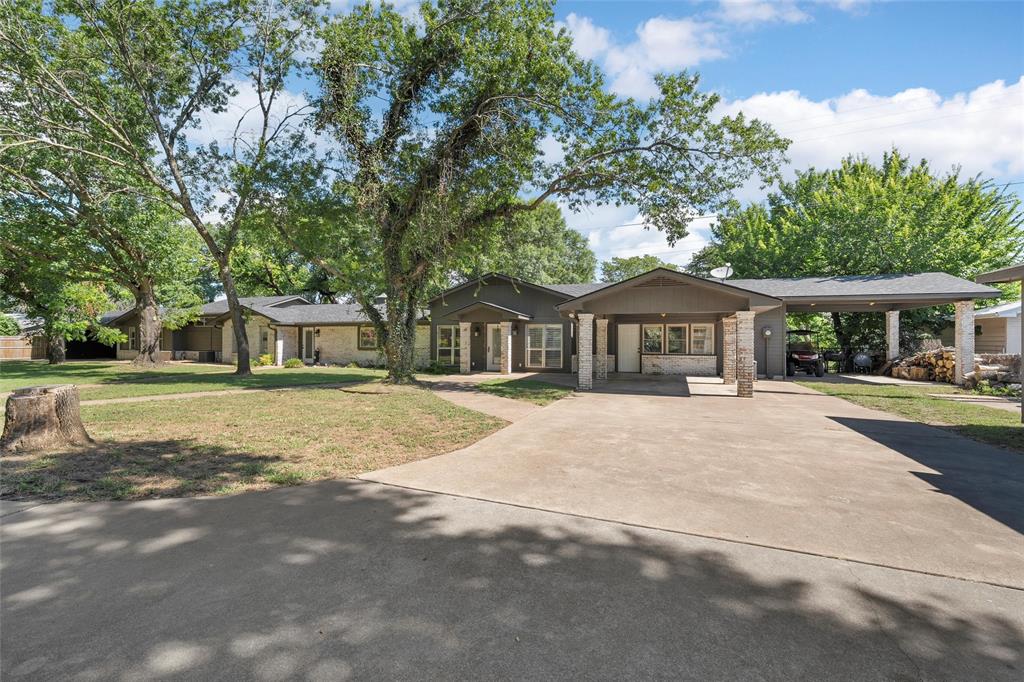 1396 Eagle Canyon Drive China Spring, TX 76633 - Photo 7 of 40 View of front facade featuring concrete driveway, a front yard, and a carport