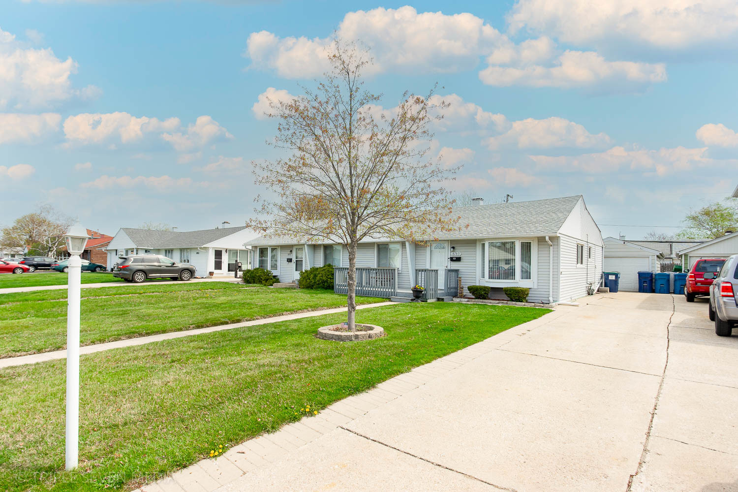 8763 South Corcoran Road Hometown, IL 60456 - Photo 3 of 28 a view of a white house in front of a big yard