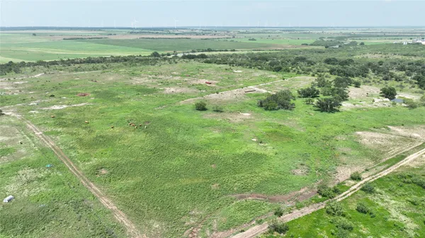 a view of a field with an ocean view