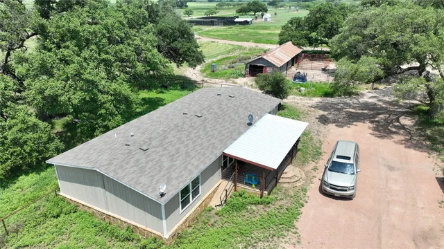 an aerial view of a house having yard