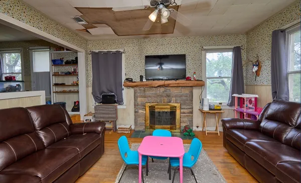 a living room with furniture a flat screen tv and a fireplace